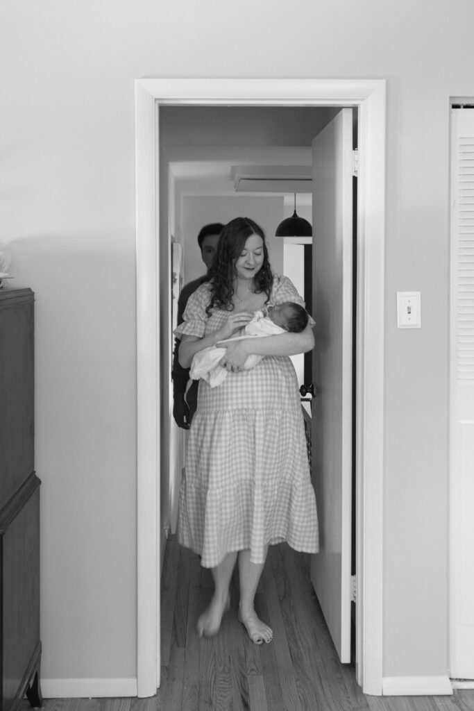 mom walking holding her baby girl